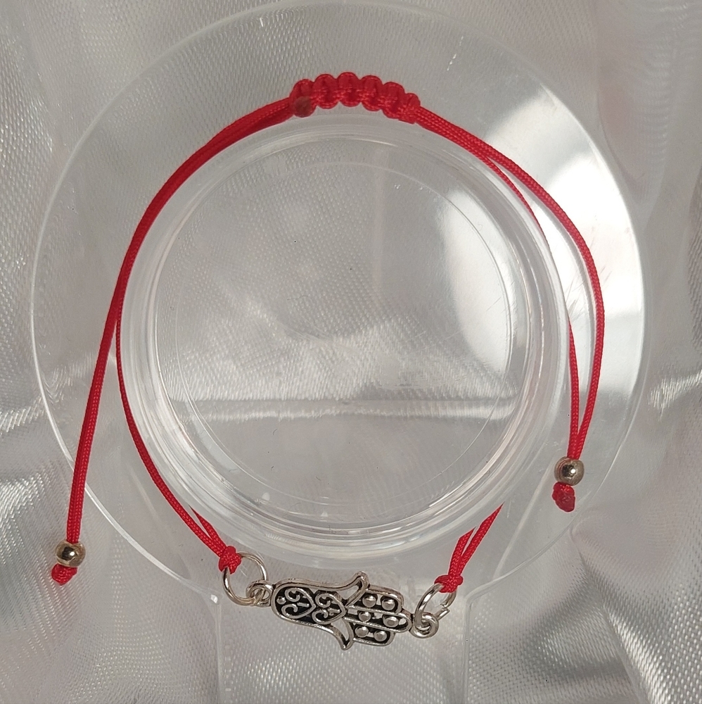 Beautiful red bracelet with a hand charm